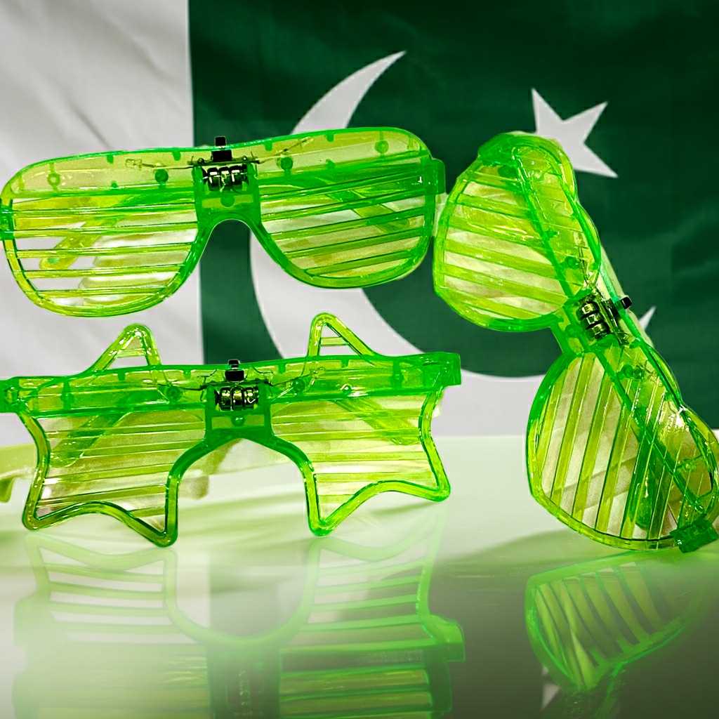 Three pairs of bright neon green shutter-style sunglasses arranged on a reflective white surface, with a green, white, and black flag in the background.