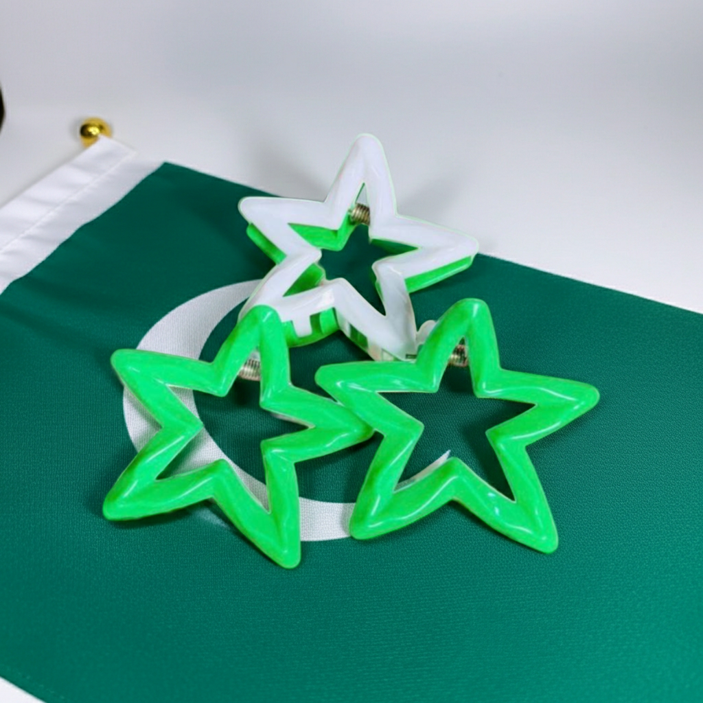 Three star-shaped plastic cookie cutters in green and white, arranged on a green and white circular flag.