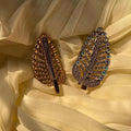 Two decorative hair clips on a yellow fabric background