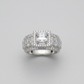 Silver ring with a large central gemstone and smaller stones on a gray background