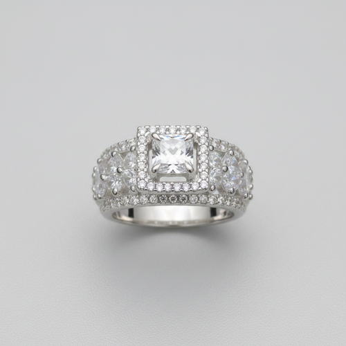 Silver ring with a large central gemstone and smaller stones on a gray background