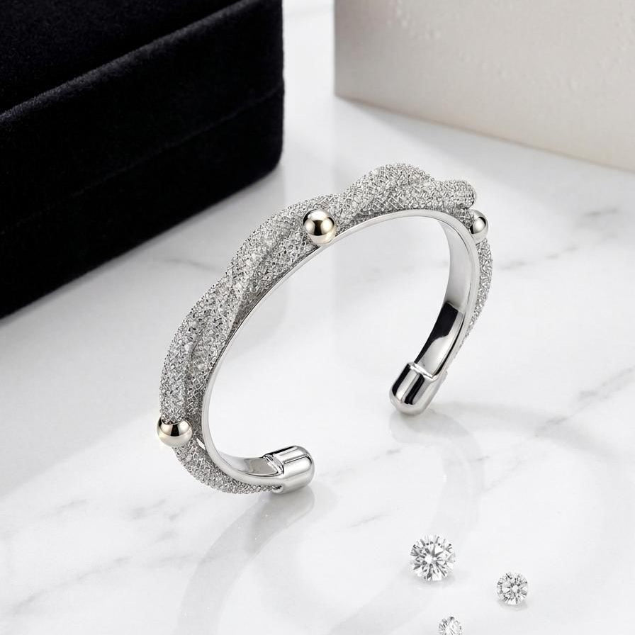 Silver bracelet with sparkling stones on a marble surface