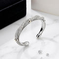 Silver bracelet with sparkling stones on a marble surface