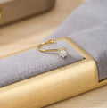 Gold ring with a diamond on a gold jewelry box