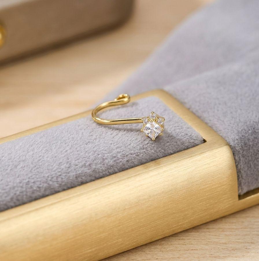 Gold ring with a diamond on a gold jewelry box