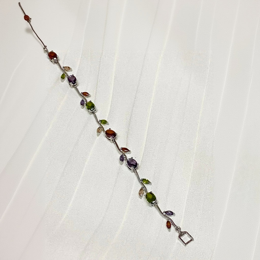 Multicolored gemstone bracelet on a white fabric background