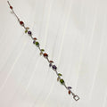 Multicolored gemstone bracelet on a white fabric background