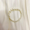Pearl bracelet on a white fabric background