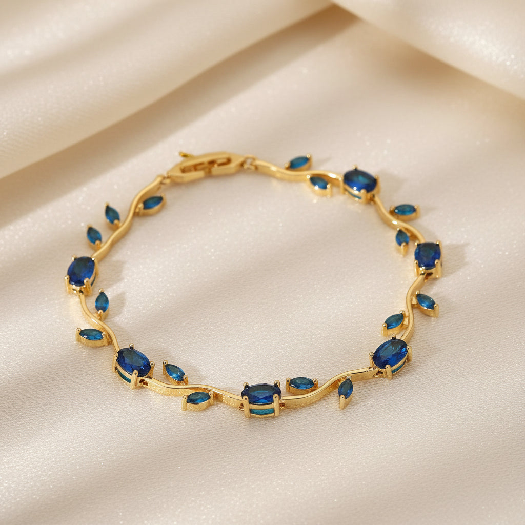 Gold bracelet with blue stones on a beige background
