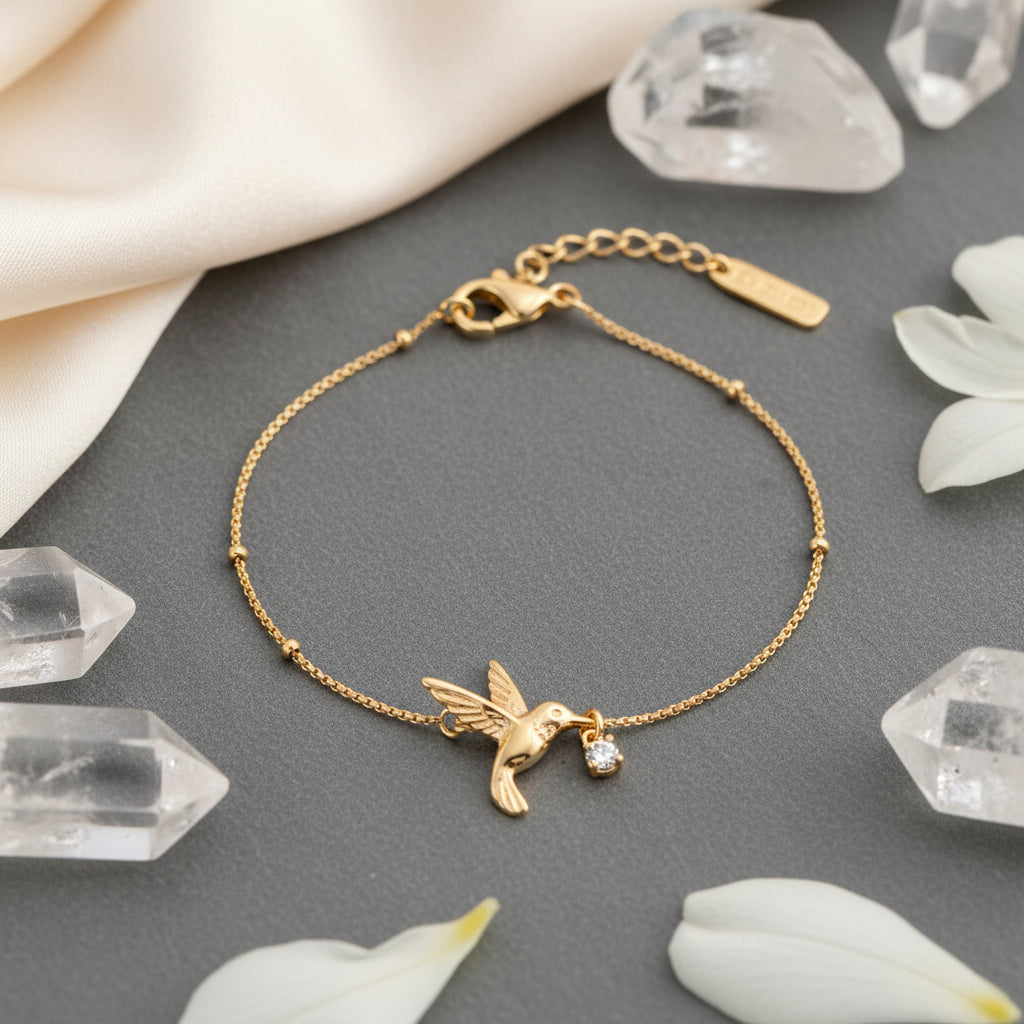 Gold bracelet on a gray surface with crystals