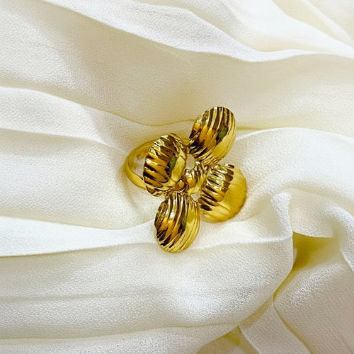 Gold ring on a white fabric background
