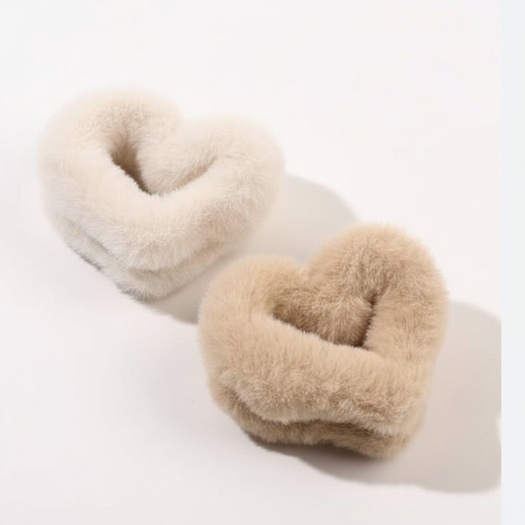 Heart-shaped beige cushions on a white surface
