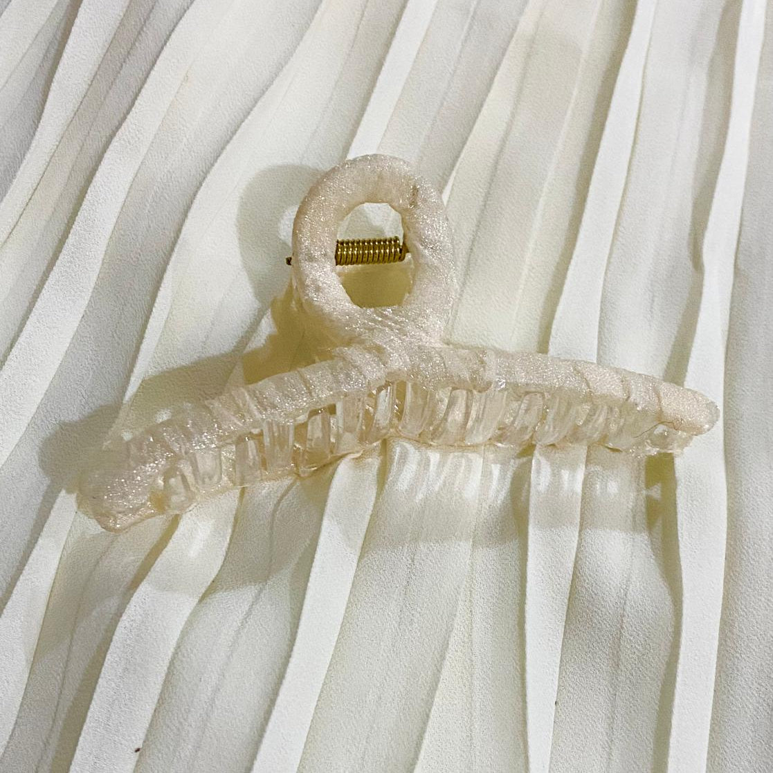 Clear plastic hanger on a white curtain background