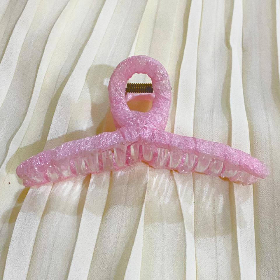 Pink plastic hanger on a white curtain background