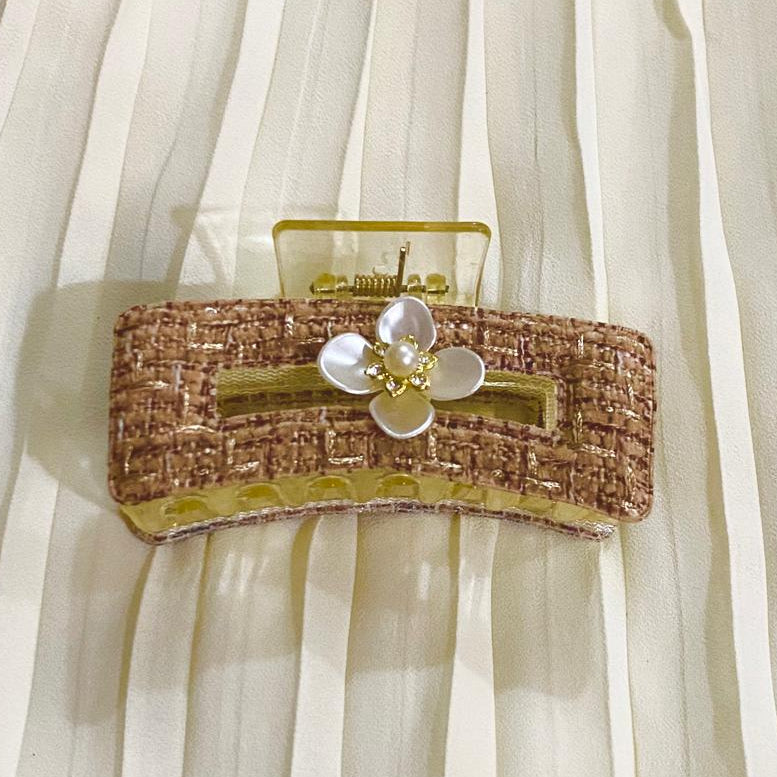 Clutch bag with floral design on a sheer white fabric background