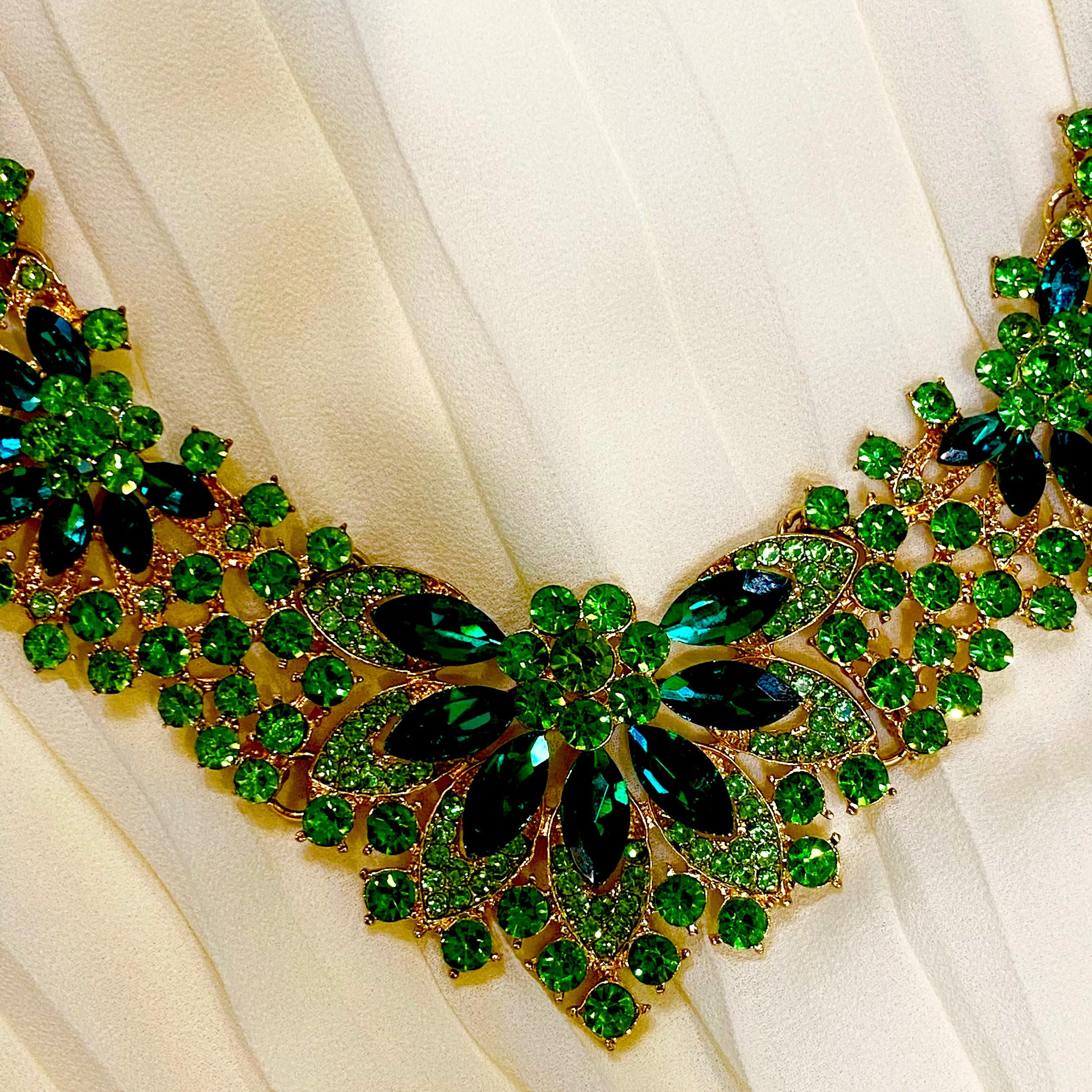 Green gemstone necklace on a white fabric background
