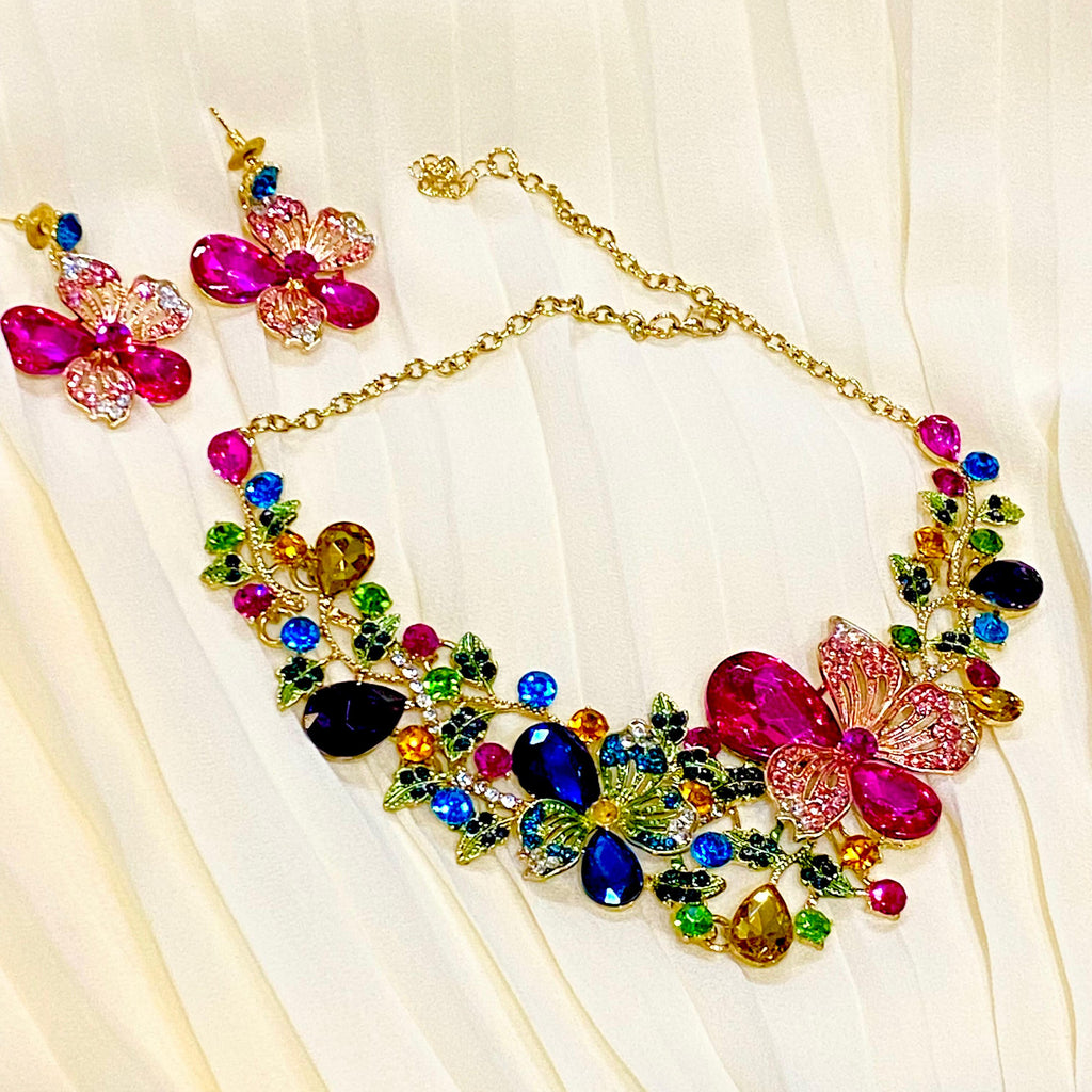 Colorful jewelry set with necklace and earrings on a light fabric background