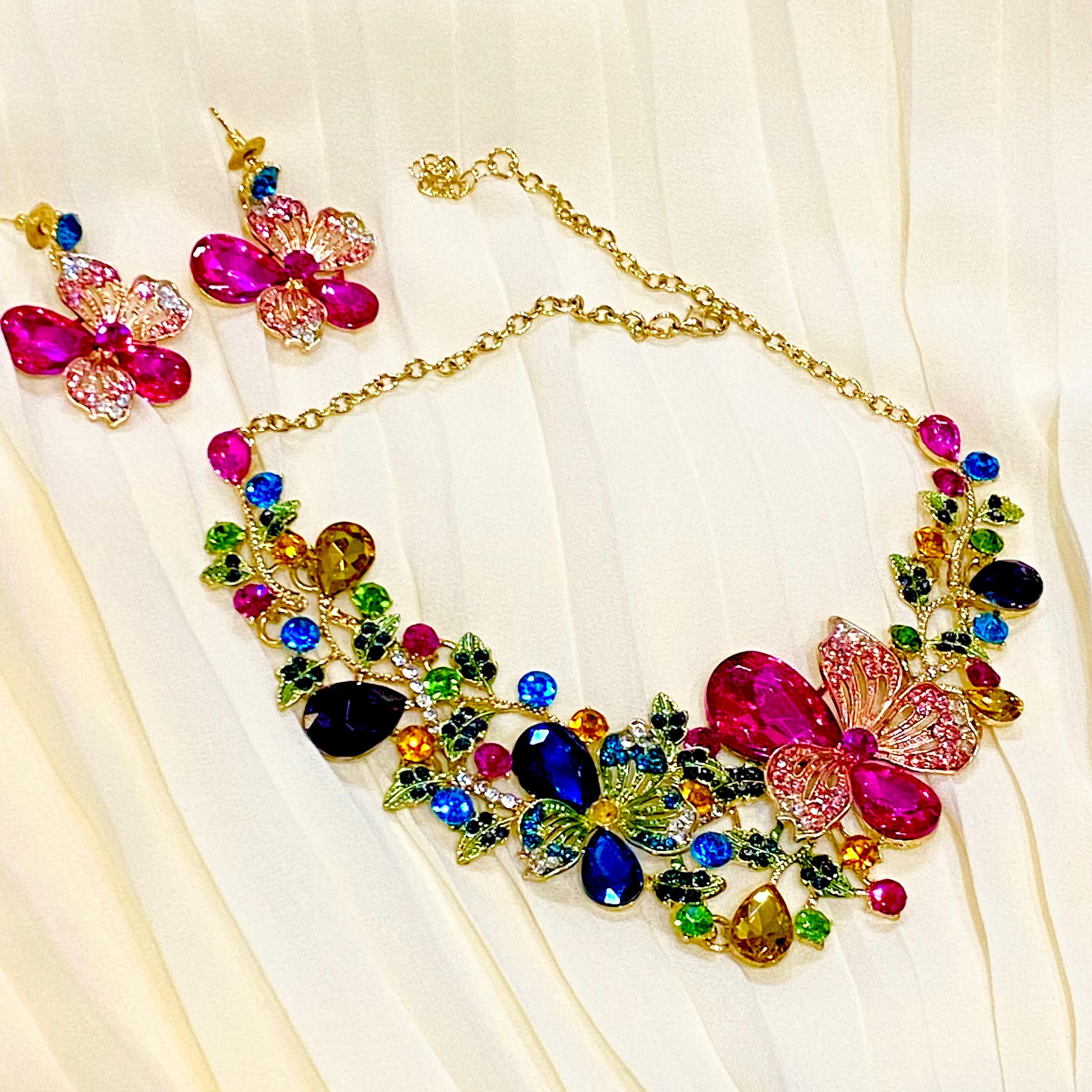 Colorful jewelry set with necklace and earrings on a light fabric background