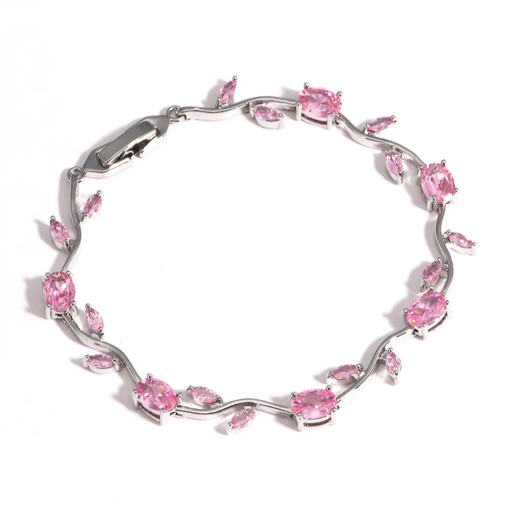 Silver bracelet with pink gemstones on a white background