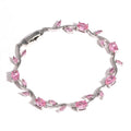 Silver bracelet with pink gemstones on a white background